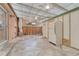 View of the home's enclosed patio featuring concrete floors, ceiling fans, a refrigerator, and additional storage at 544 S Xenon Ct, Lakewood, CO 80228