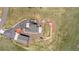 Overhead aerial view of home featuring professional landscaping, lush lawn, stone patio, fire pit, and three-car garage at 3434 Antelope Ridge Trl, Parker, CO 80138