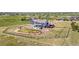 Property aerial view showcases a sprawling fenced backyard, a stone patio, and a charming pergola with outdoor seating at 3434 Antelope Ridge Trl, Parker, CO 80138