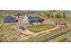 Aerial view of a property with manicured landscaping, fenced yard, outdoor living areas, and a detached three-car garage at 3434 Antelope Ridge Trl, Parker, CO 80138