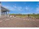 Sprawling backyard featuring a stone patio, playset, and a tranquil pond, perfect for Gathering enjoyment at 3434 Antelope Ridge Trl, Parker, CO 80138