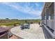 Backyard patio with dining area, stone fire pit, and a playground with scenic views of the landscape at 3434 Antelope Ridge Trl, Parker, CO 80138