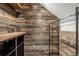 Unique basement storage with wood paneling, custom wine storage, and metal shelving system at 3434 Antelope Ridge Trl, Parker, CO 80138