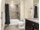 Bathroom with a black-and-white shower curtain and a dark vanity with a granite countertop at 3434 Antelope Ridge Trl, Parker, CO 80138