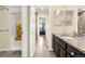 Bathroom showcasing granite-topped vanity and walk-in closet, complemented by a tiled floor at 3434 Antelope Ridge Trl, Parker, CO 80138