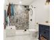 Modern bathroom featuring a tiled shower, glass door, and dark blue vanity with white countertops at 3434 Antelope Ridge Trl, Parker, CO 80138