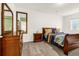 Bedroom with dark wood furnishings and a large mirror adds dimension to the cozy space at 3434 Antelope Ridge Trl, Parker, CO 80138