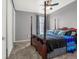 Comfortable bedroom featuring a four-poster bed, neutral carpeting, a window with decorative curtains and natural light at 3434 Antelope Ridge Trl, Parker, CO 80138
