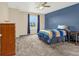 Bedroom features a large window with blue curtains, a ceiling fan, and neutral walls at 3434 Antelope Ridge Trl, Parker, CO 80138