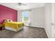 Bright bedroom with yellow bedspread, neutral walls, and a window providing natural light at 3434 Antelope Ridge Trl, Parker, CO 80138
