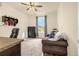 Bright bedroom with neutral carpet, a brown loveseat, and a window overlooking a nice view at 3434 Antelope Ridge Trl, Parker, CO 80138