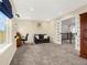 Bonus room with comfortable seating and desk area, bathed in natural light, with gray carpeted floor at 3434 Antelope Ridge Trl, Parker, CO 80138