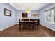 Cozy dining room with modern chandelier and dark wood furniture, adjacent to a well-appointed wet bar at 3434 Antelope Ridge Trl, Parker, CO 80138