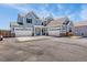 Impressive two-story home boasts a three-car garage, a neutral gray exterior, and a vast paved driveway at 3434 Antelope Ridge Trl, Parker, CO 80138