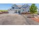 Charming two-story home featuring stone accents, a three-car garage, a manicured lawn, and a spacious driveway at 3434 Antelope Ridge Trl, Parker, CO 80138