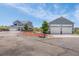Sprawling property featuring a well-maintained home and detached garage, set against a lush green backdrop at 3434 Antelope Ridge Trl, Parker, CO 80138