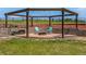 Charming backyard fire pit area with stone seating and lush landscaping, ideal for cozy evenings at 3434 Antelope Ridge Trl, Parker, CO 80138