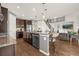 Open-concept kitchen with dark wood cabinets, granite countertops, and seamless flow into living spaces at 3434 Antelope Ridge Trl, Parker, CO 80138