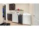 Efficient laundry room with modern appliances, ample storage space, and practical shelving for organization at 3434 Antelope Ridge Trl, Parker, CO 80138