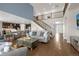 Inviting living room with staircase, open-concept design, and dark wood flooring at 3434 Antelope Ridge Trl, Parker, CO 80138