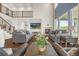 Bright living room features large windows, a stone fireplace, and an airy, open layout at 3434 Antelope Ridge Trl, Parker, CO 80138