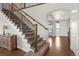 Inviting home with a carpeted staircase and decorative iron railings and hardwood floors extending to the entry at 3434 Antelope Ridge Trl, Parker, CO 80138
