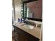Bathroom featuring granite countertop and a large framed mirror with vines at 4320 Nepal St, Denver, CO 80249