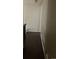 Dark wood floors in hallway featuring baseboard heat and neutral paint at 4320 Nepal St, Denver, CO 80249