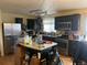 Spacious kitchen with dark cabinets and a center island at 4320 Nepal St, Denver, CO 80249