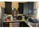 View of kitchen featuring dark cabinets, granite countertops and stainless steel dishwasher at 4320 Nepal St, Denver, CO 80249
