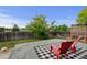 Inviting backyard deck with red chairs and a black and white rug, perfect for outdoor relaxation and entertainment at 2588 E 116Th Ave, Thornton, CO 80233