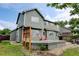 Backyard with deck, green lawn, mature tree and a two story home at 2588 E 116Th Ave, Thornton, CO 80233