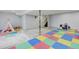 Large basement with colorful flooring, perfect for a ' playroom and relaxation space at 2588 E 116Th Ave, Thornton, CO 80233