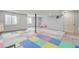 Versatile basement space with colorful flooring, natural light, and potential for customization at 2588 E 116Th Ave, Thornton, CO 80233