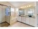Luxurious bathroom with dual vanities, a glass-enclosed shower, and a soaking tub at 2588 E 116Th Ave, Thornton, CO 80233
