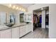 Bathroom featuring double sinks, walk-in closet and gray tile floors at 2588 E 116Th Ave, Thornton, CO 80233