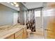 Stylish bathroom with a marble countertop, decorative shower curtain, and modern fixtures at 2588 E 116Th Ave, Thornton, CO 80233