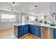 Modern kitchen features an island with sink and dishwasher and provides open access to living spaces at 2588 E 116Th Ave, Thornton, CO 80233