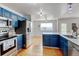 Updated kitchen with stainless steel appliances and stylish blue cabinetry and hardware at 2588 E 116Th Ave, Thornton, CO 80233