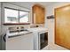 A laundry room with washer and dryer and wooden door at 2588 E 116Th Ave, Thornton, CO 80233