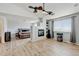 Spacious living room with fireplace, ceiling fans, wood floors and room for a bedroom at 2588 E 116Th Ave, Thornton, CO 80233