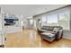An open-concept space with hardwood floors and a comfortable seating area near large windows at 2588 E 116Th Ave, Thornton, CO 80233