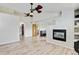 Open-concept living room with fireplace, wood floors and attached bathroom at 2588 E 116Th Ave, Thornton, CO 80233