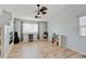 Open living room features a fireplace, light wood floors and large window at 2588 E 116Th Ave, Thornton, CO 80233