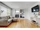 Bright and open living room with hardwood floors and a fireplace at 2588 E 116Th Ave, Thornton, CO 80233