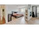Open bedroom with a fireplace, light-colored floor, and calming natural light at 2588 E 116Th Ave, Thornton, CO 80233