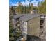 Exterior of mountain condo building with balconies and mountain views surrounded by trees at 1179 Ski Hill Rd # 147, Breckenridge, CO 80424