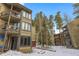Condo exterior view showcases multiple levels with balconies and wintery landscaping at 1179 Ski Hill Rd # 147, Breckenridge, CO 80424