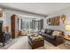 Cozy living room featuring a wood-burning stove, plush seating, and a view of the snowy outdoors at 1179 Ski Hill Rd # 147, Breckenridge, CO 80424