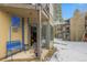 Inviting condo patio with a blue bench offers a charming outdoor space at 1179 Ski Hill Rd # 147, Breckenridge, CO 80424